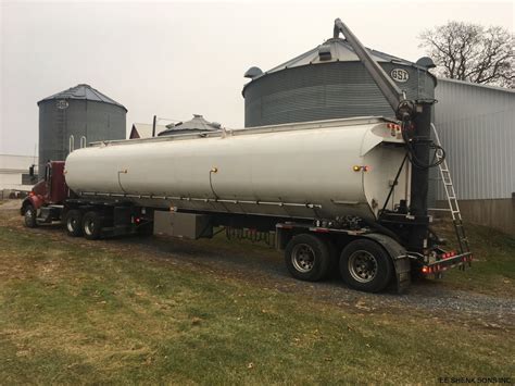 A 1960s chicken feed truck parked in a field