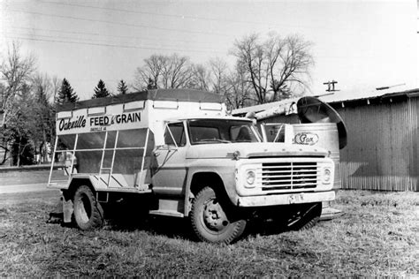 A restored 1960s chicken feed truck on display at a vintage car show