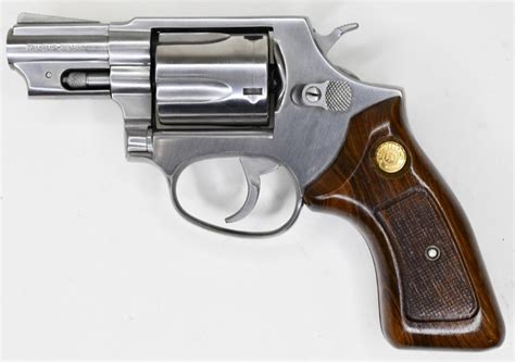 A.38 Special handgun with a holster, lying on a wooden table