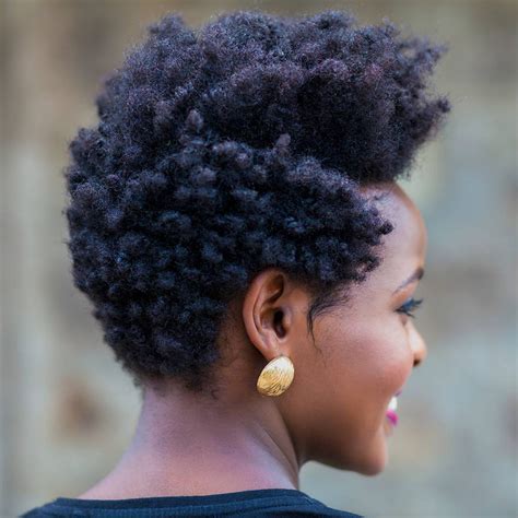 A young woman with 4c hair styled in a classic puff, paired with Air Force Ones