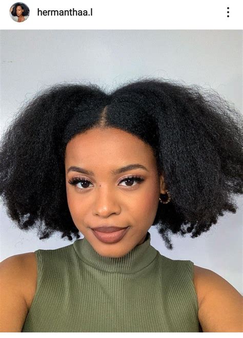 A young woman with 4c hair styled in a side swept fringe, paired with Air Force Ones