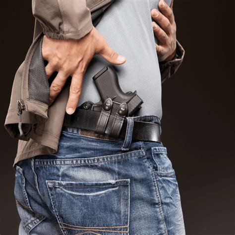 A person holding a handgun with a background of a city