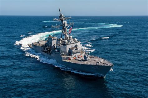 A photograph of a destroyer sailing through the ocean