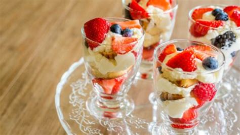 A fruit salad with whipped cream and nuts