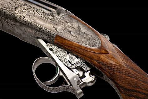 An artisan engraving a handgun