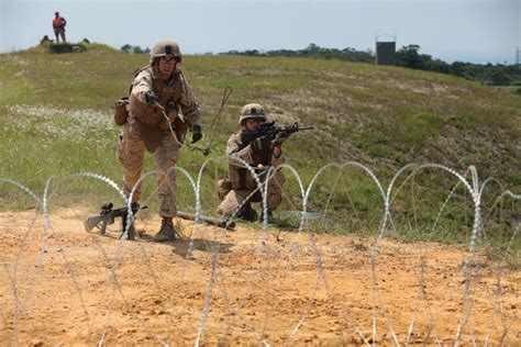 Marine Corps Combat Engineers breaching obstacles