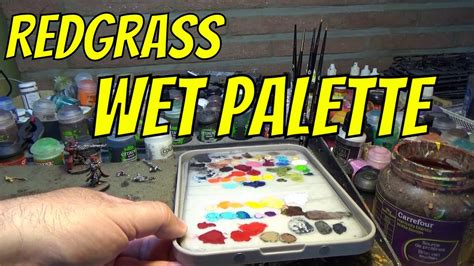 A miniature painter adjusting the moisture levels on the Redgrass Wet Palette