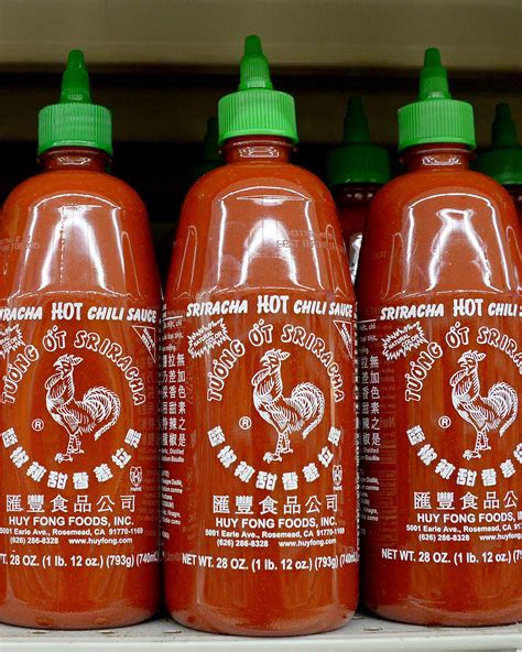 A bottle of sriracha sauce with a spicy label