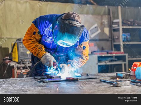 Image of a welder at work on a Navy warship