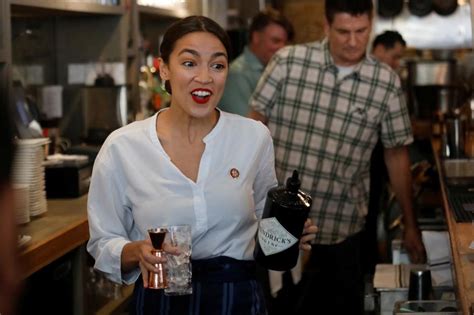 AOC pouring drinks behind the bar