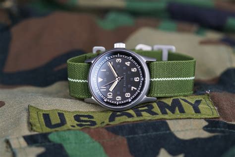 A man wearing an Army watch original in a rugged outdoor setting