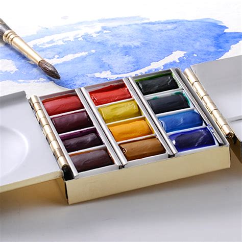 Artist holding a brass watercolor palette