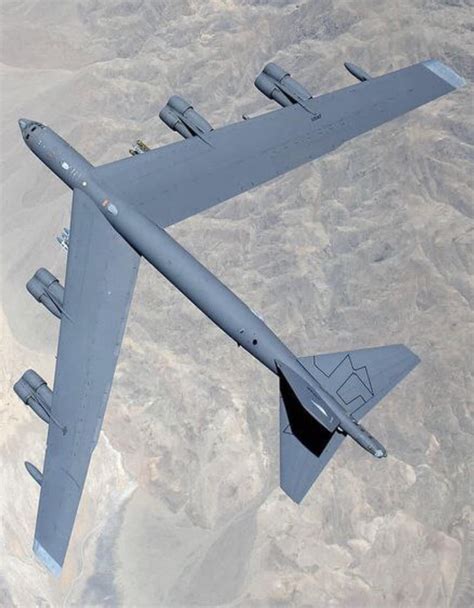 B-52 Stratofortress in flight, with vapor trails streaming behind