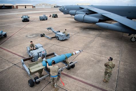 B-52 Stratofortress undergoing maintenance, with technicians working on the engines