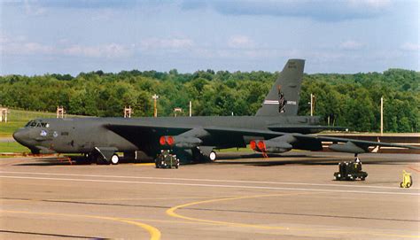 B-52 Stratofortress parked on the tarmac, with ground crew attending to it