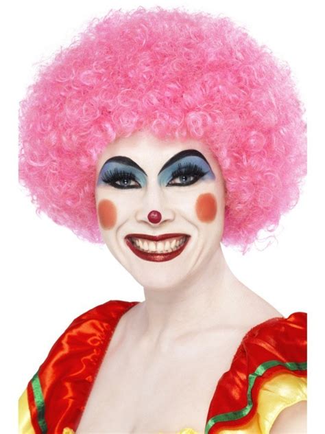 A clown wearing a pink nose