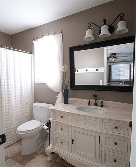 A bathroom with cream-colored walls and taupe-colored fixtures