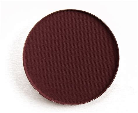 A deep plum eyeshadow applied to the outer corner of the eye