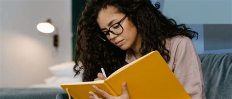 A person feeling relieved and happy after writing in their diary