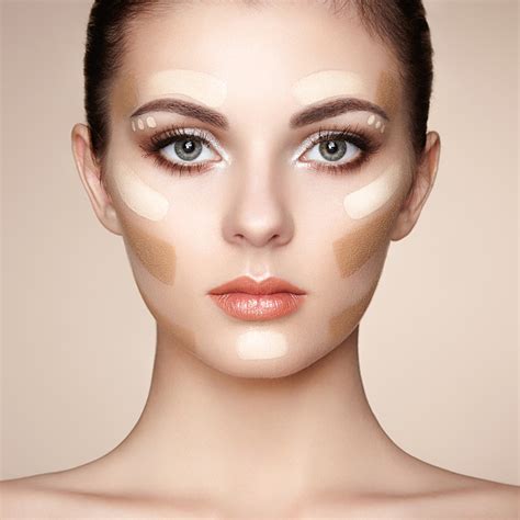 A person blending a face palette cream