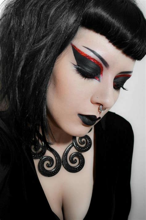 A gothic-inspired makeup look featuring red and black hues