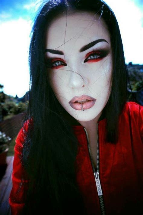 A gothic-inspired beauty look featuring red and black hues