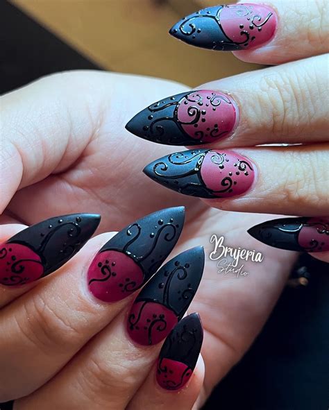 Gothic-inspired nail art featuring red and black hues