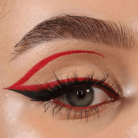 A close-up of a graphic liner design on a model's eyebrow