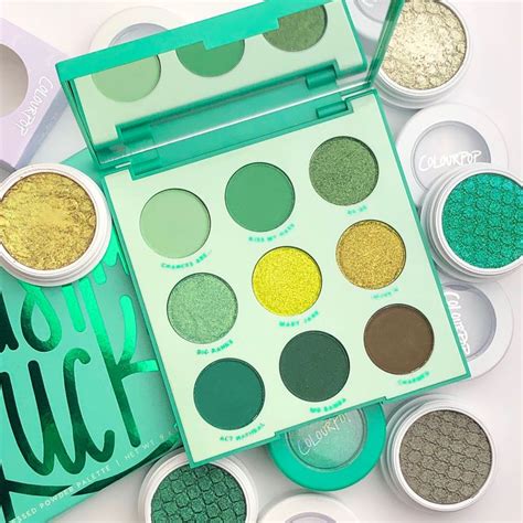 A green eye palette with various shades of eyeshadow