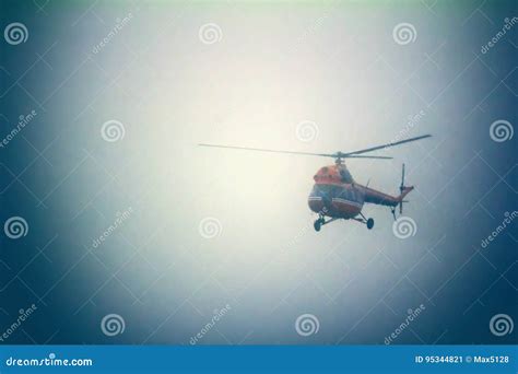 A helicopter flying through fog or mist, with a sense of mystery and uncertainty