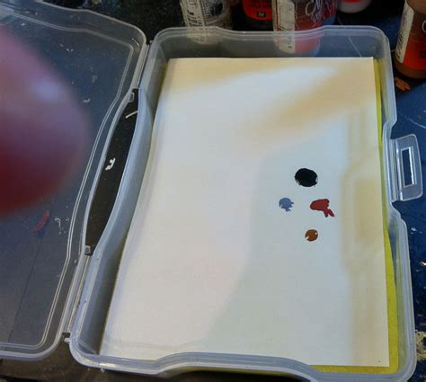 A homemade wet palette made from a plastic container