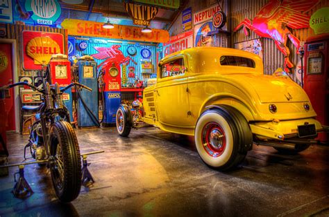 A hot rod in a garage, surrounded by tools and parts