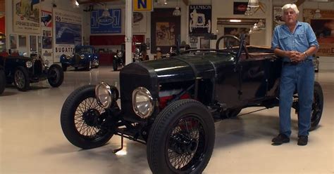 Early hot rod enthusiasts posing with their vehicles