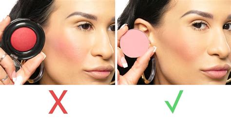 A woman fixing her blush and highlighter application