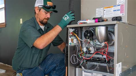 A person installing a new HVAC system in a home