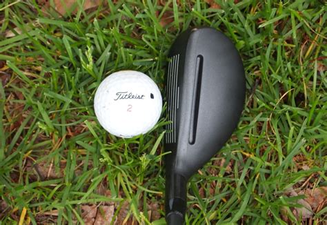 Golfer using a hybrid golf club in the sand