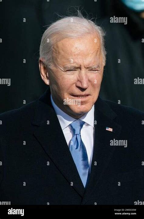 Joe Biden putting his hands on the shoulders of Senator Heidi Heitkamp's husband