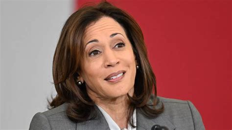 Kamala Harris speaking at a podium, showing emotional vulnerability