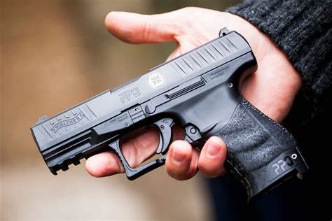 Left-handed shooter firing a handgun