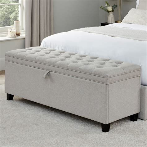 A blow up ottoman used for storage and organization in a bedroom