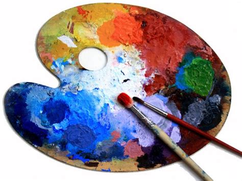 A close-up of a palette with paint and brushes