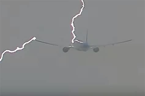 A plane flying through a stormy sky with lightning in the background