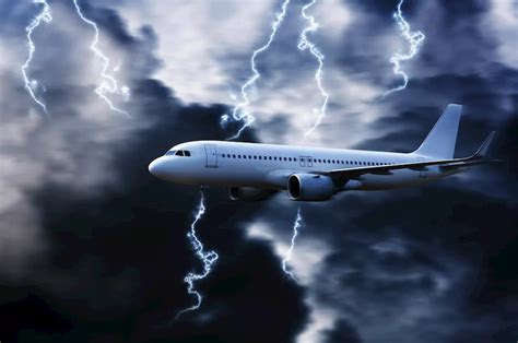 A plane flying through a stormy sky with lightning in the background