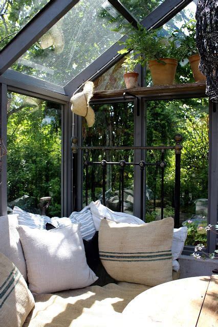 A cozy porch glider with pillows and a book