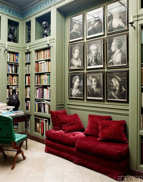 A bold red and green vase adds a pop of color to a neutral living room.