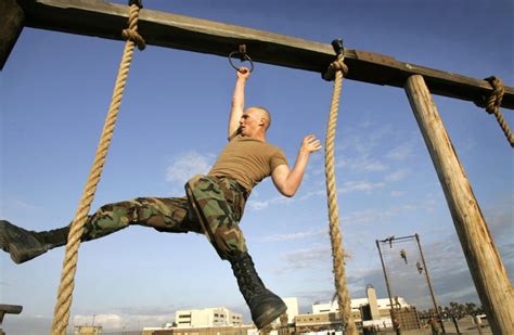 Navy SEALs navigating obstacle course