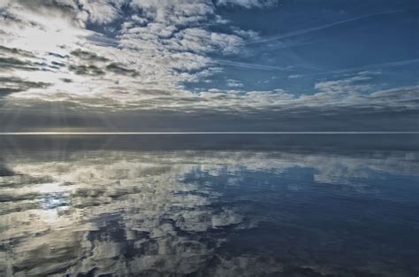 Aerial view of a serene beach where the sea meets the sky