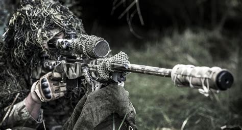 Soldier with gun in sniper position