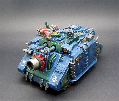 A Space Marine tank firing its cannons at enemy forces