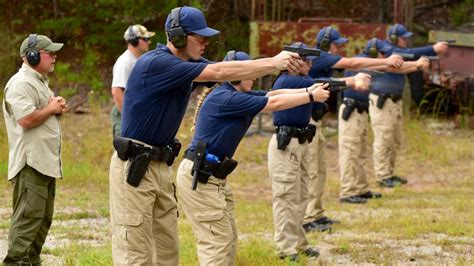 Police officers training with standard issue pistols